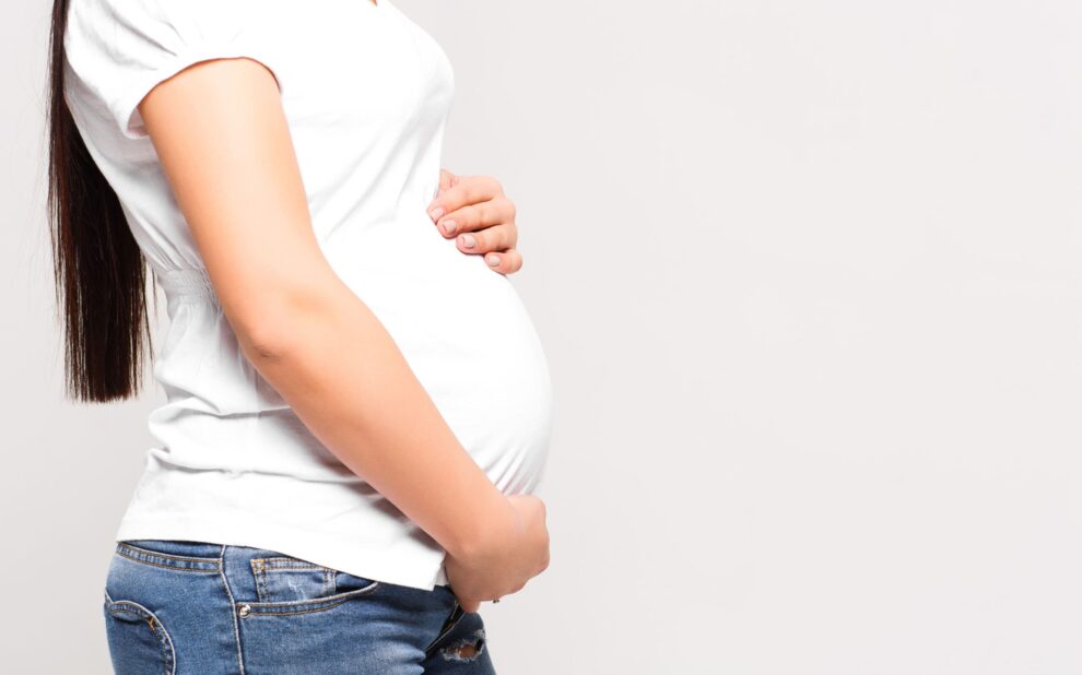 cost of surrogacy in colombia- pregnant in white t-shirt