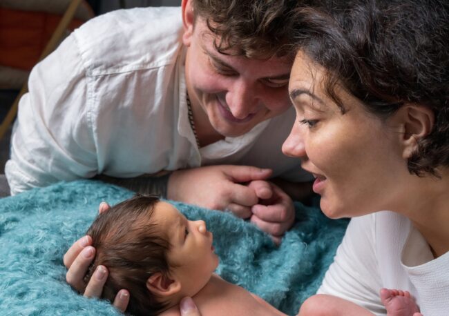 Parents holding newborn after surrogacy in the US in hospital setting